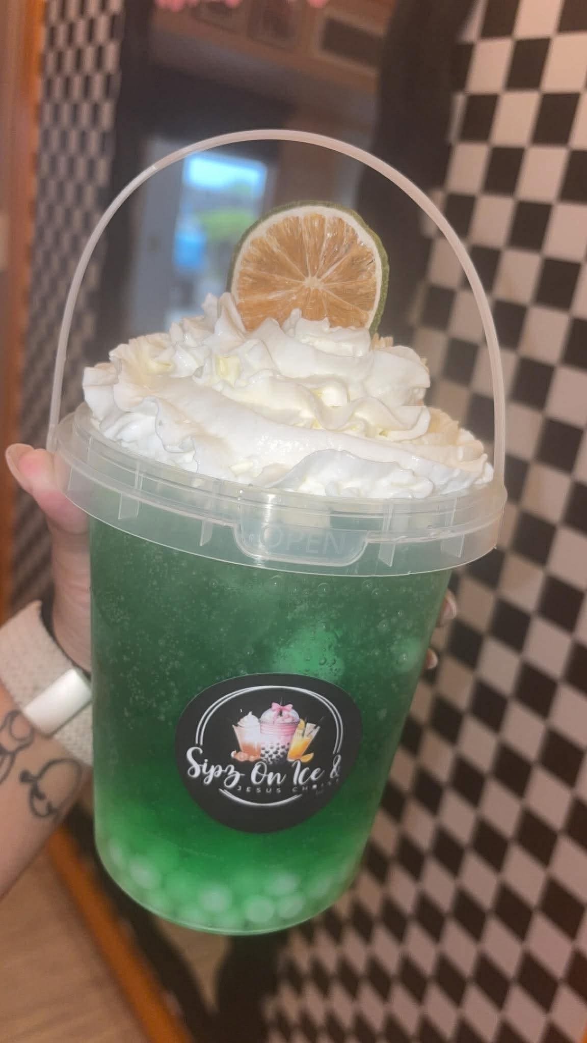 Bucket-style drink with whipped cream and a dehydrated citrus garnish