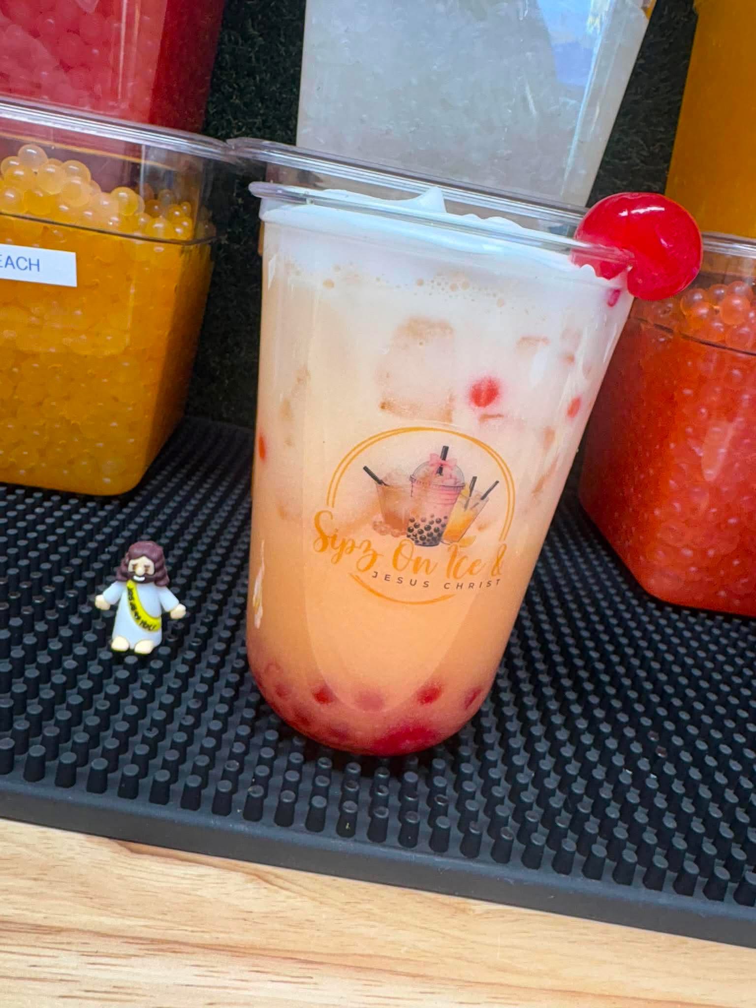 A Sipz On Ice drink with boba pearl toppings in the background