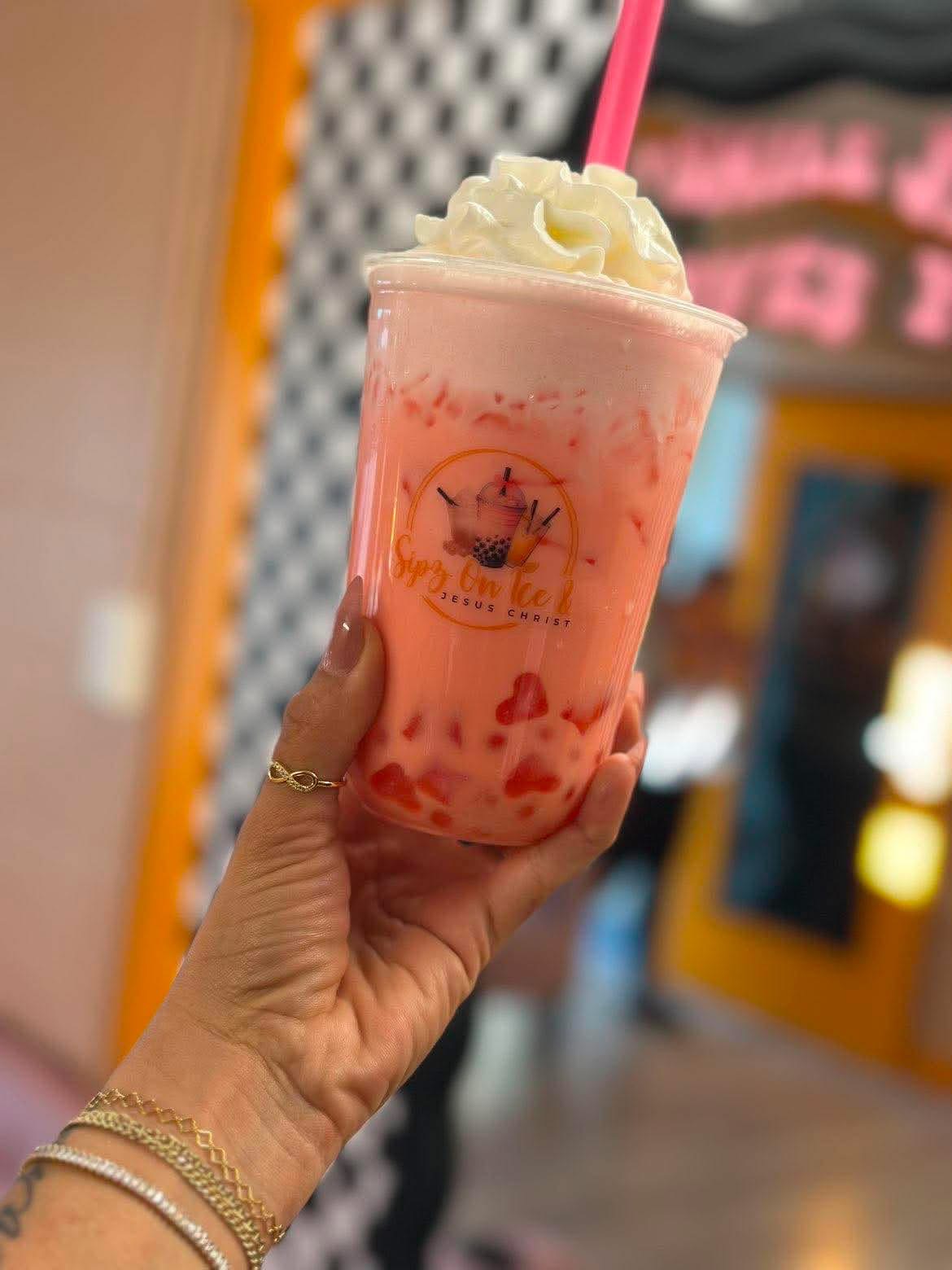 Pink Italian cream soda topped with whipped cream